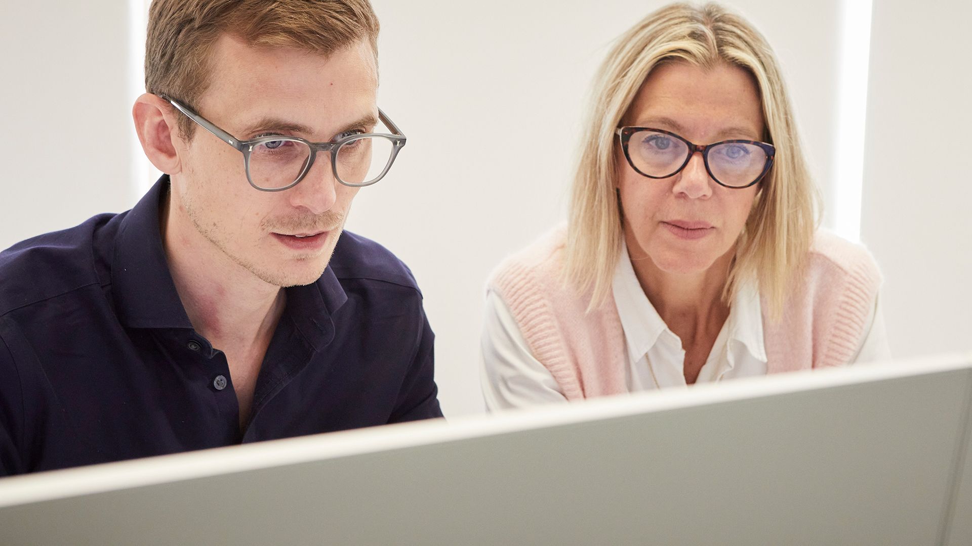 Two people collaborating at a computer
